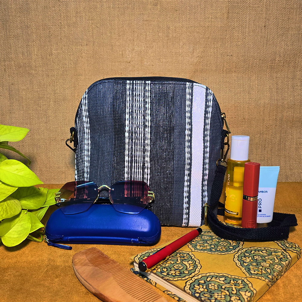 Rajiben- Black & White Stripe Upcycled Plastic Handwoven curved rectangular Sling Bag
